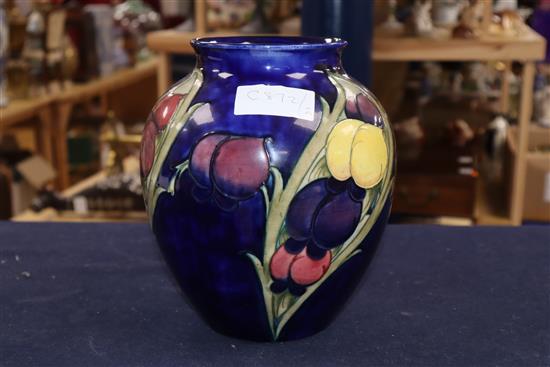 A Moorcroft blue ground Wisteria pattern vase height 22cm